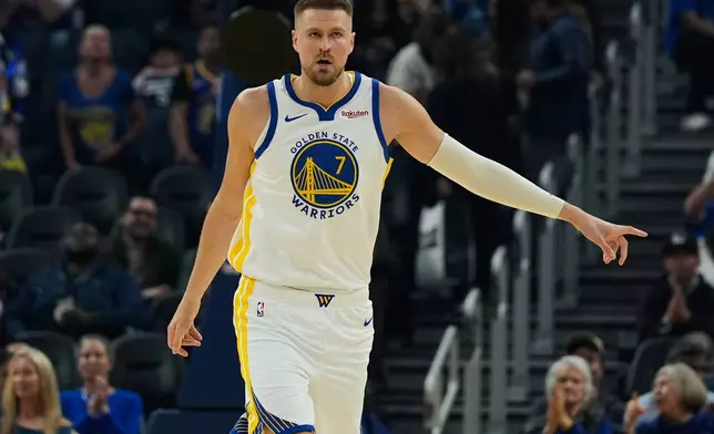Golden State Warriors center Kristaps Porzingis (7) reacts after making a 3-point basket against the Minnesota Timberwolves during the first half of an NBA basketball game Friday, March 13, 2026, in San Francisco. (AP Photo/Godofredo A. Vásquez)