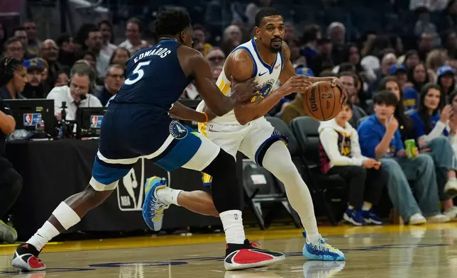 Golden State Warriors guard De'Anthony Melton, right, moves the ball while defended by Minnesota Timberwolves guard Anthony Edwards during the first half of an NBA basketball game Friday, March 13, 2026, in San Francisco. (AP Photo/Godofredo A. Vásquez)