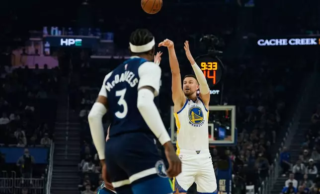 Golden State Warriors center Kristaps Porzingis (7) shoots a 3-point basket against the Minnesota Timberwolves during the first half of an NBA basketball game Friday, March 13, 2026, in San Francisco. (AP Photo/Godofredo A. Vásquez)