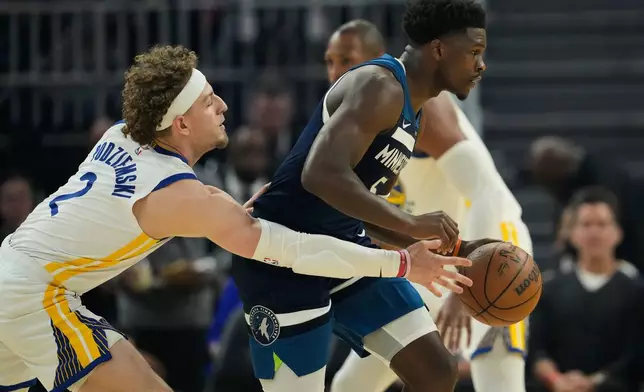 Golden State Warriors guard Brandin Podziemski (2) defends Minnesota Timberwolves guard Anthony Edwards (5) during the first half of an NBA basketball game Friday, March 13, 2026, in San Francisco. (AP Photo/Godofredo A. Vásquez)