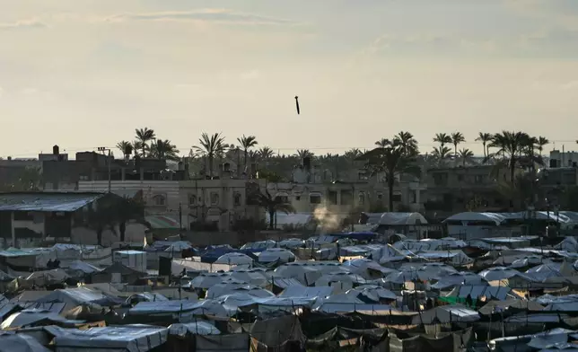 An Israeli bomb drops toward a target next to a tent camp in Deir al-Balah, central Gaza Strip, Wednesday, March 25, 2026. (AP Photo/Abdel Kareem Hana)