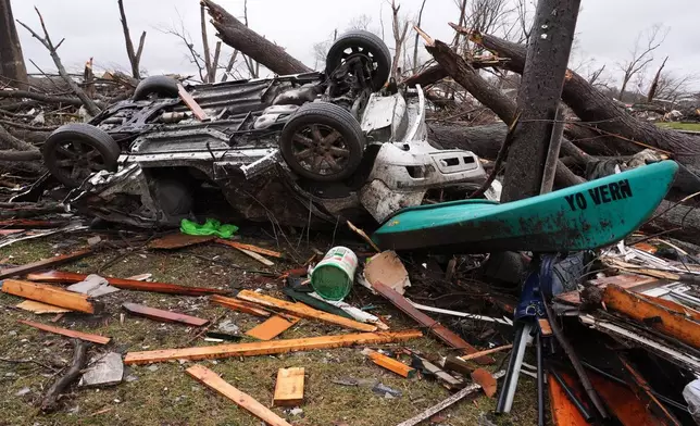A damaged vehicle lies upside down amid debris in the aftermath of a powerful storm that ripped through the area a day earlier, in Aroma Park, Ill., Wednesday, March 11, 2026. (AP Photo/Nam Y. Huh)