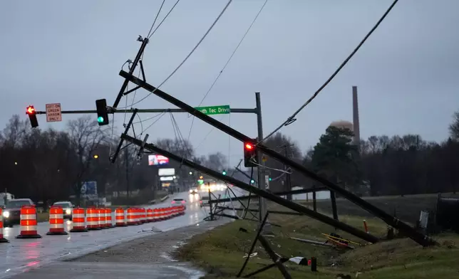 Utility poles are damaged in the aftermath of a powerful storm that ripped through the area a day earlier in Kankakee, Ill., Wednesday, March 11, 2026. (AP Photo/Nam Y. Huh)