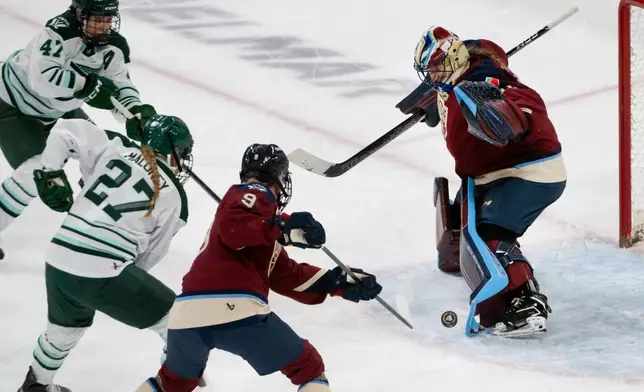 Montreal Victoire goaltender Ann-Renee Desbiens, right, deflects a shot off her pads during third-period PWHL hockey game action against the Boston Fleet in Laval, Quebec, Sunday March 15, 2026. (Peter McCabe/The Canadian Press via AP)