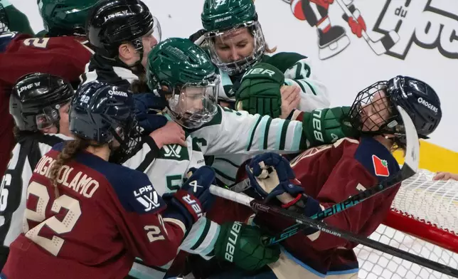 Montreal Victoire's Laura Stacey, right, takes a punch to the facemask from Boston Fleet's Megan Keller (5) during third-period PWHL hockey game action in Laval, Quebec, Sunday March 15, 2026. (Peter McCabe/The Canadian Press via AP)