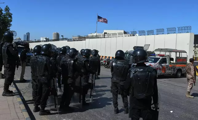 Pakistani security officers stand guard to ensure security outside the U.S. Consulate in Karachi, Pakistan, Wednesday, March 4, 2026. (AP Photo/Ali Raza)