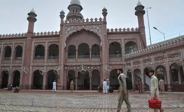 Muslim worshippers arrive to observes "Itikaf," during the last ten days of the Islamic fasting on month of Ramadan, at a mosque, in Peshawar, Pakistan, Tuesday, March 10, 2026. (AP Photo/Muhammad Sajjad)