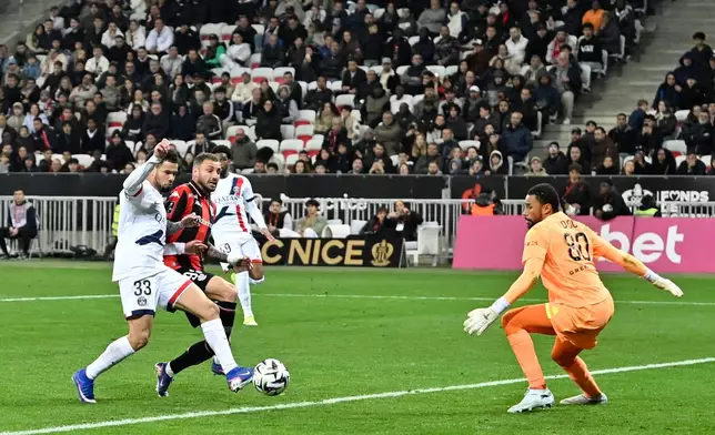 PSG's Warren Zaire-Emery, left, scores his side's fourth goal during the French League One soccer match between Nice and Paris Saint-Germain in Nice, France, Saturday, March 21, 2026. (AP Photo/Philippe Magoni)