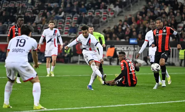 PSG's Desire Doue scores his side's second goal during the French League One soccer match between Nice and Paris Saint-Germain in Nice, France, Saturday, March 21, 2026. (AP Photo/Philippe Magoni)