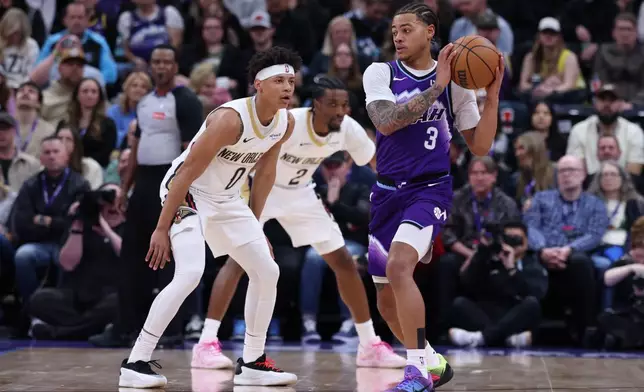 Utah Jazz guard Keyonte George (3) looks for a play as New Orleans Pelicans guard Jeremiah Fears (0) defends during the first half of an NBA basketball game, Saturday, Feb. 28, 2026, in Salt Lake City. (AP Photo/Rob Gray)