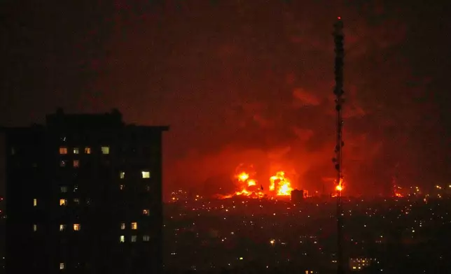 Flames rise from an oil storage facility south of the capital Tehran as strikes hit the city during the U.S.–Israel military campaign, Iran, Saturday, March 7, 2026. (AP Photo/Vahid Salemi)