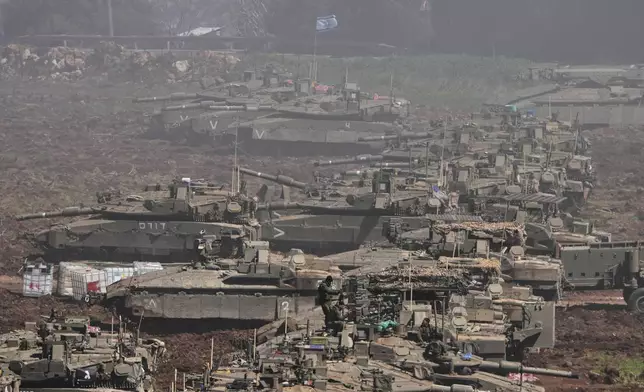 Israeli tanks are parked in a staging area in northern Israel near the border with Lebanon, Israel, Sunday, March 8, 2026. (AP Photo/Ariel Schalit)