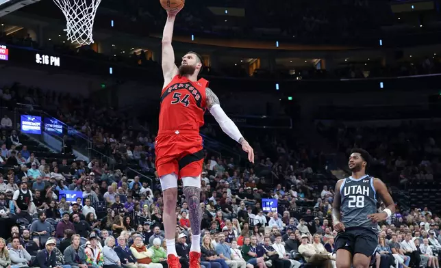 Toronto Raptors forward Sandro Mamukelashvili (54) goes up for a dunk against the Utah Jazz during the second half of an NBA basketball game, Monday, March 23, 2026, in Salt Lake City. (AP Photo/Rob Gray)