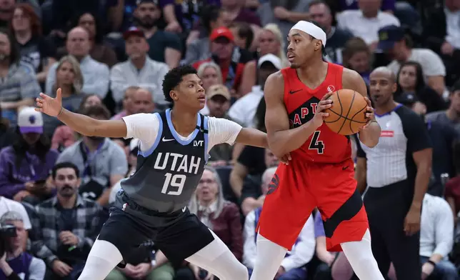 Toronto Raptors forward Scottie Barnes (4) looks for a play as Utah Jazz guard Ace Bailey (19) defends during the first half of an NBA basketball game, Monday, March 23, 2026, in Salt Lake City. (AP Photo/Rob Gray)
