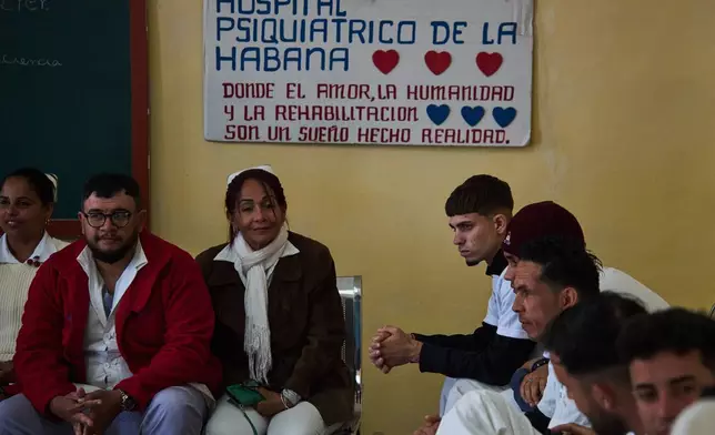 Medical staff, left, and people in rehabilitation, right, sit at a psychiatric hospital in Havana, Cuba, Wednesday, Feb. 25, 2026. (AP Photo/Ramon Espinosa)