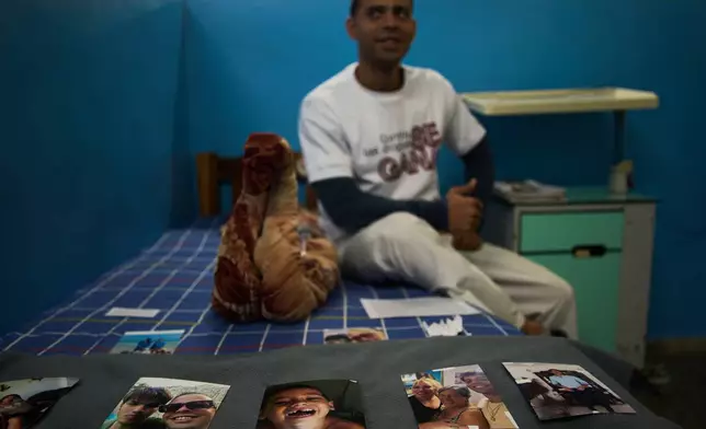 A youth in rehabilitation sits on his bed next to photos of his family that he uses as support for his recovery at a psychiatric hospital in Havana, Cuba, Wednesday, Feb. 25, 2026. (AP Photo/Ramon Espinosa)