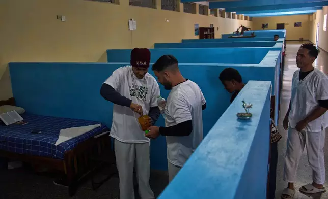 People in rehabilitation at a psychiatric hospital prepare a homemade cocoa cream candy to share in Havana, Cuba, Wednesday, Feb. 25, 2026. (AP Photo/Ramon Espinosa)