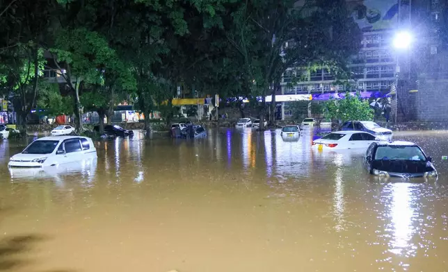 Cars are seen submerged after heavy rains flooded roads in Nairobi, Kenya, on Friday, March 6, 2026. (AP Photo/Andrew Kasuku)