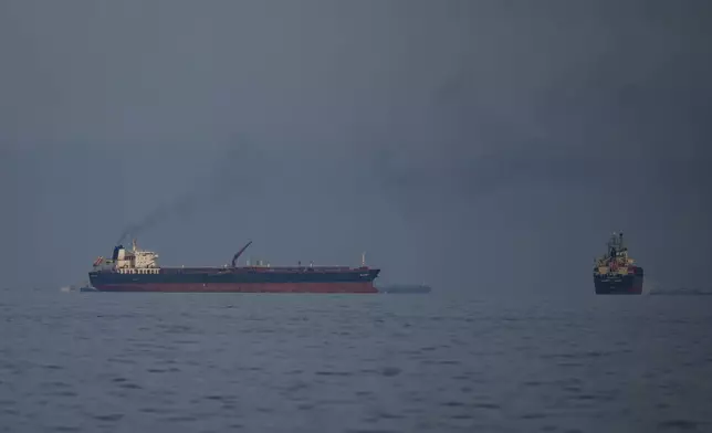 Oil tankers and cargo ships line up in the Strait of Hormuz as seen from Khor Fakkan, United Arab Emirates, Wednesday, March 11, 2026. (AP Photo/Altaf Qadri)
