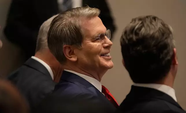 Treasury Secretary Scott Bessent, left, sits next to Defense Secretary Pete Hegseth as President Donald Trump speaks at the Shield of the Americas Summit, Saturday, March 7, 2026, at Trump National Doral Miami in Doral, Fla.(AP Photo/Mark Schiefelbein)