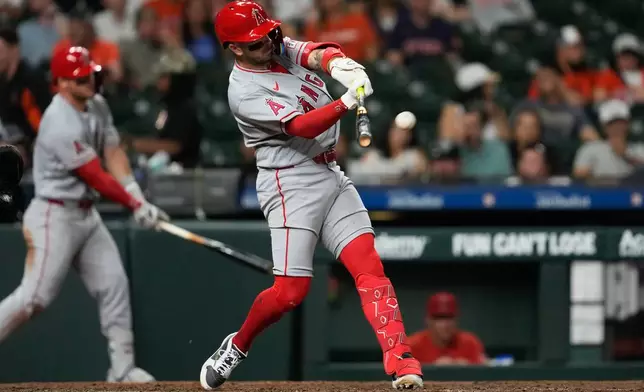 Los Angeles Angels' Zach Neto hits a home run during the ninth inning of a baseball game against the Houston Astros in Houston, Friday, March 27, 2026. (AP Photo/Ashley Landis)