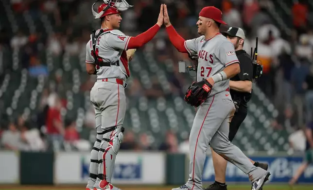 Los Angeles Angels catcher Logan O'Hoppe (14) celebrates with center fielder Mike Trout (27) after winning a baseball game against the Houston Astros in Houston, Friday, March 27, 2026. (AP Photo/Ashley Landis)