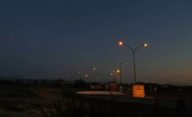 The gate of the U.K.'s RAF Akrotiri air base at sunset after it was struck by a drone earlier in the morning near Limassol, Cyprus, Monday, March 2, 2026. (AP Photo/Petros Karadjias)