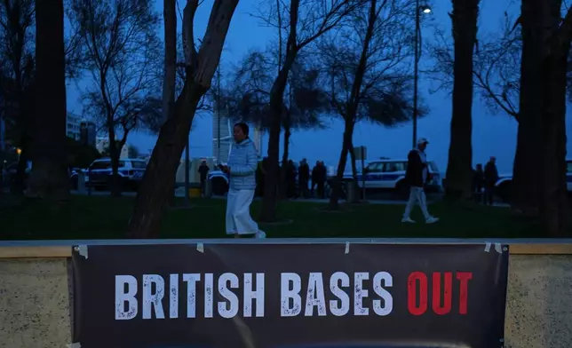 A phrase "British bases out," hangs during an anti-war rally in the southern city of Limassol, Cyprus, Tuesday, March 3, 2026. (AP Photo/Petros Karadjias)