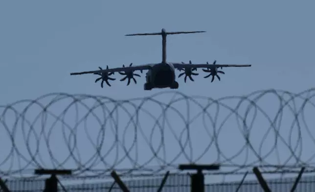 A transport aircraft prepares for landing at U.K.'s RAF Akrotiri air base near Limassol, Cyprus, Tuesday, March, 3, 2026. (AP Photo/Petros Karadjias)