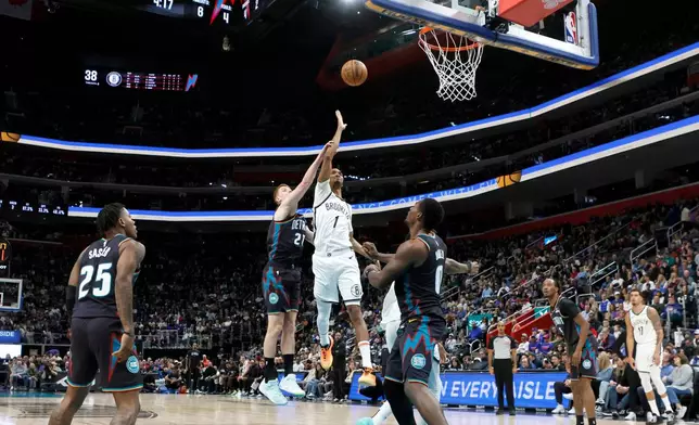 Brooklyn Nets forward Ziaire Williams (1) gets past Detroit Pistons guard Kevin Huerter (27) for a shot during the first half of an NBA basketball game Saturday, March 7, 2026, in Detroit. (AP Photo/Duane Burleson)