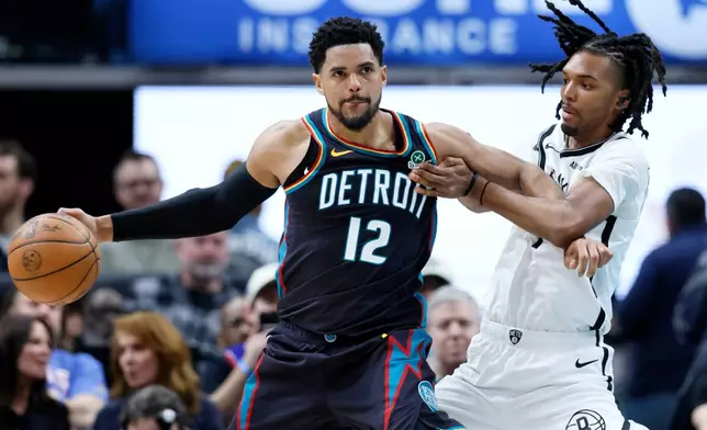 Detroit Pistons forward Tobias Harris (12) drives against Brooklyn Nets forward Ziaire Williams, right, during the first half of an NBA basketball game Saturday, March 7, 2026, in Detroit. (AP Photo/Duane Burleson)