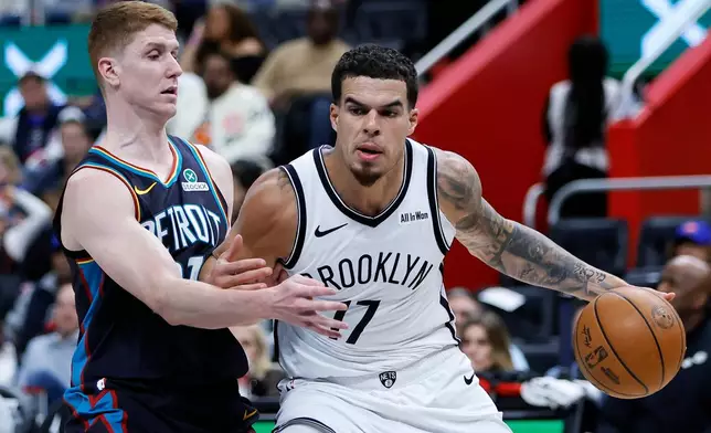 Brooklyn Nets forward Michael Porter Jr. (17) drives with the ball against Detroit Pistons guard Kevin Huerter, left, during the first half of an NBA basketball game Saturday, March 7, 2026, in Detroit. (AP Photo/Duane Burleson)