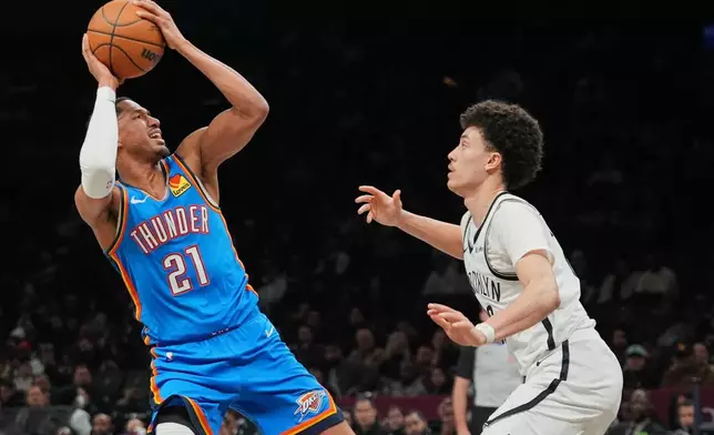Oklahoma City Thunder's Aaron Wiggins (21) shoots over Brooklyn Nets' Nolan Traore (88) during the second half of an NBA basketball game Wednesday, March 18, 2026, in New York. (AP Photo/Frank Franklin II)