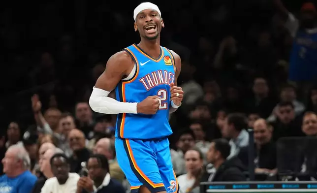 Oklahoma City Thunder's Shai Gilgeous-Alexander (2) celebrates after a teammate he passed the ball to hit a three-point shot during the second half of an NBA basketball game against the Brooklyn Nets Wednesday, March 18, 2026, in New York. (AP Photo/Frank Franklin II)