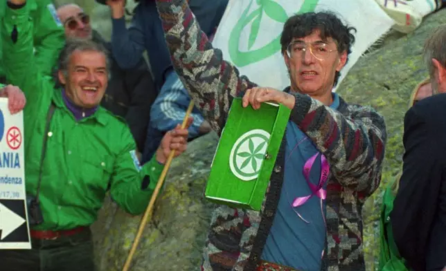 Umberto Bossi, populist leader of the Northern League, holds a flask of water which he has just taken from the source of the Po River in Crissolo northern Italy, Sept. 13, 1996. Bossi died at the age of 84 on Thursday, March 19, 2026. (AP Photo/Luca Bruno, File)