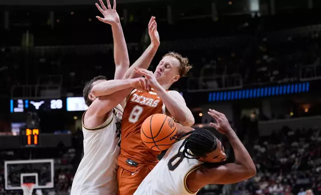 Texas center Matas Vokietaitis (8) works for a rebound against Purdue guard C.J. Cox (0) during the first half in the Sweet 16 of the NCAA college basketball tournament, Thursday, March 26, 2026, in San Jose, Calif. (AP Photo/Godofredo A. Vásquez)
