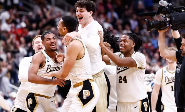 Purdue forward Trey Kaufman-Renn, center, celebrates with teammates after making the game-winning basket during the second half in the Sweet 16 of the NCAA college basketball tournament against Texas, Thursday, March 26, 2026, in San Jose, Calif. (AP Photo/Kelley L Cox)