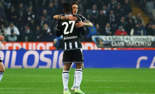 Udinese's Christian Kabasele, back, celebrates after scoring during the Italian Serie A soccer match between Udinese and Fiorentina in Udine, Italy, Monday, March 2, 2026. (Andrea Bressanutti/LaPresse via AP)
