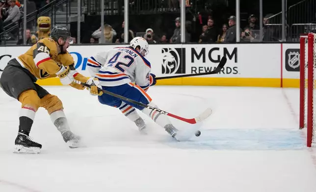 Edmonton Oilers right wing Kasperi Kapanen (42) scores on an open net against the Vegas Golden Knights during the third period of an NHL hockey game Sunday, March 8, 2026, in Las Vegas. (AP Photo/John Locher)