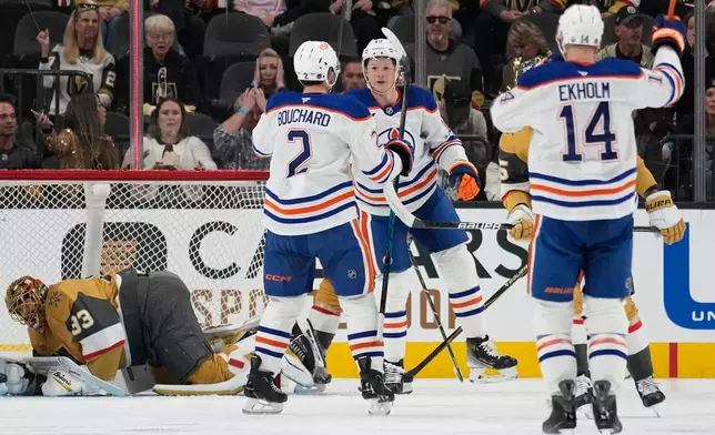 Edmonton Oilers center Trent Frederic, center, celebrates after scoring against the Vegas Golden Knights during the second period of an NHL hockey game Sunday, March 8, 2026, in Las Vegas. (AP Photo/John Locher)