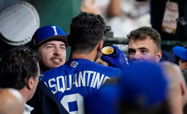 Italy first baseman Vinnie Pasquantino celebrates a home run with an expresso in the second inning of a World Baseball Classic game against Mexico, Wednesday, March 11, 2026, in Houston. (AP Photo/Ashley Landis)