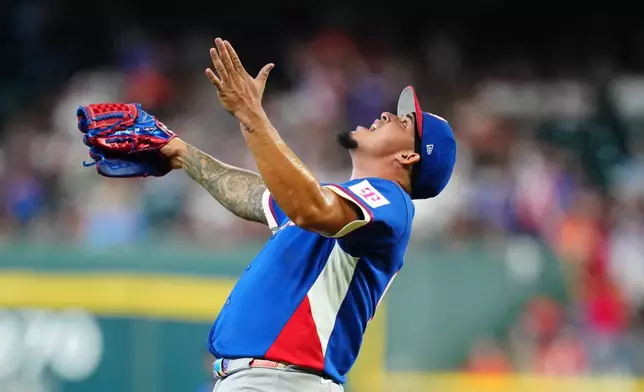 Puerto Rico pitcher Eduardo Rivera celebrates after striking out Italy's Vinnie Pasquantino during the second inning of a World Baseball Classic quarterfinal game, Saturday, March 14, 2026, in Houston. (AP Photo/Karen Warren)