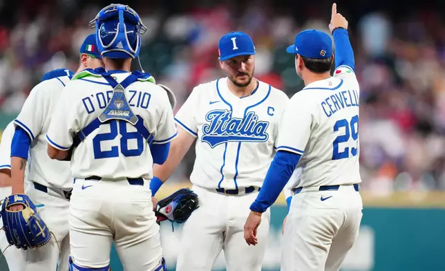 Italy manager Francisco Cervelli (29) removes starting pitcher Sam Aldegheri as catcher JJ D'Orazio (28) watches during the second inning of a World Baseball Classic quarterfinal game against Puerto Rico, Saturday, March 14, 2026, in Houston. (AP Photo/Karen Warren)