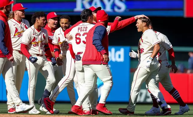 St. Louis Cardinals' JJ Wetherholt, right, is congratulated by teammates after driving in the game-winning runs in the tenth inning of a baseball game against the Tampa Bay Rays, Saturday, March 28, 2026, in St. Louis. (AP Photo/Scott Kane)