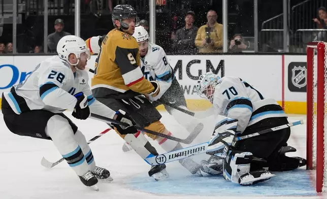 Utah Mammoth defenseman Ian Cole (28) knocks the puck away from Vegas Golden Knights center Jack Eichel (9) during the second period of an NHL hockey game Thursday, March 19, 2026, in Las Vegas. (AP Photo/John Locher)