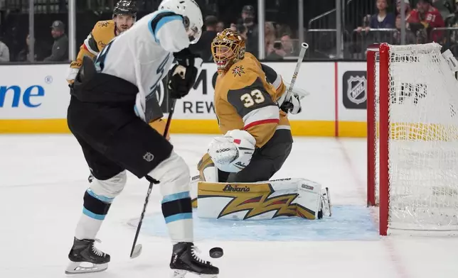 Utah Mammoth right wing Clayton Keller (9) shoots to score against Vegas Golden Knights goaltender Adin Hill (33) during the first period of an NHL hockey game Thursday, March 19, 2026, in Las Vegas. (AP Photo/John Locher)