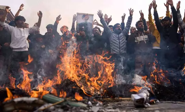 Shiite Muslims shout slogans as they burn effigies of President Donald Trump and Israeli Prime Minister Benjamin Netanyahu during a protest against the killing of Iran's Supreme Leader Ayatollah Ali Khamenei, in Budgam, northeast of Srinagar, Indian controlled Kashmir, Friday, March 6, 2026. (AP Photo/Dar Yasin)