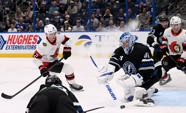 Tampa Bay Lightning goaltender Andrei Vasilevskiy (88) makes a save on a shot by Ottawa Senators center Shane Pinto (12) during the first period of an NHL hockey game Saturday, March 28, 2026, in Tampa, Fla. (AP Photo/Jason Behnken)