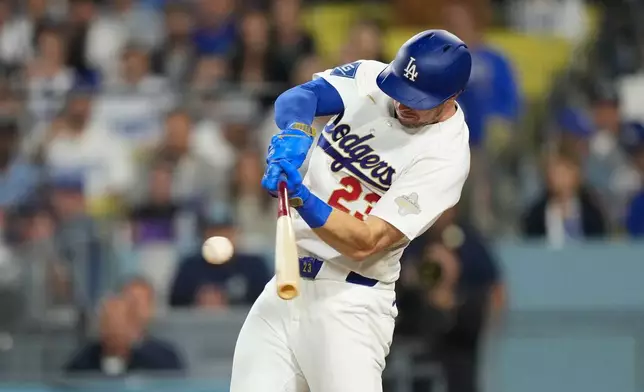 Los Angeles Dodgers' Kyle Tucker hits an RBI single during the eighth inning of a baseball game against the Arizona Diamondbacks, Friday, March 27, 2026, in Los Angeles. (AP Photo/Mark J. Terrill)