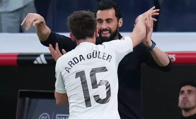 Real Madrid's Arda Guler celebrates with Real Madrid's head coach Alvaro Arbeloa after scoring his side's fourth goal during a Spanish La Liga soccer match between Real Madrid and Elche CF, in Madrid, Saturday, March 14, 2026. (AP Photo/Manu Fernandez)